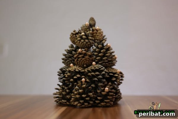 Step 8: Decorating the pinecone Christmas tree with faux pearls