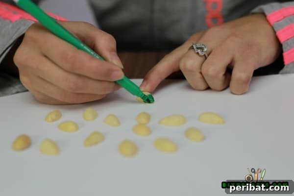 From Snack to Showpiece Pistachio Shell Wall Art 8 Pistachio shells painted in various bright colors