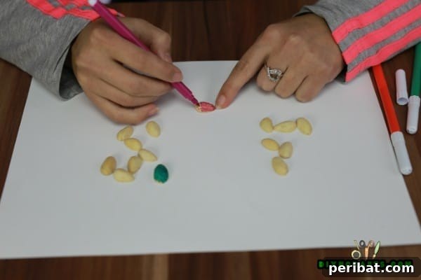 Close-up of freshly painted pistachio shells drying
