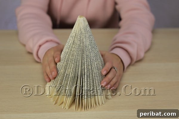 Upcycle an Old Book into a Stunning Christmas Angel 8 Assembled cone shape of the folded book pages, forming the angel's body