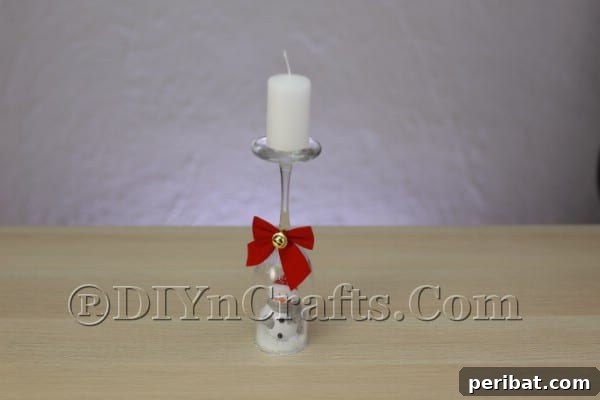 Placing a candle on top of the finished wine glass candle holder