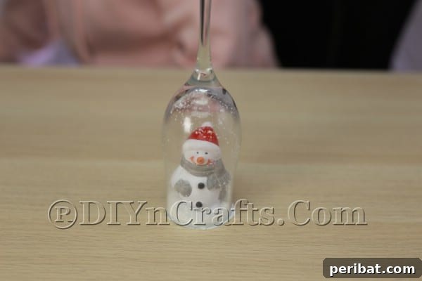 Flipping the wine glass to reveal the ornament scene