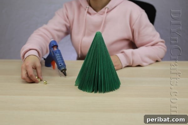 Pages to Pine: Craft a Christmas Tree from Old Books 7 Spray painting the book Christmas tree