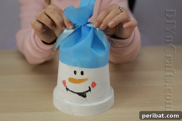 DIY Adorable Flower Pot Snowman 10 Tie a ribbon around the hat