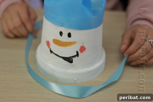 DIY Adorable Flower Pot Snowman 11 Wrap a ribbon around the base for a scarf