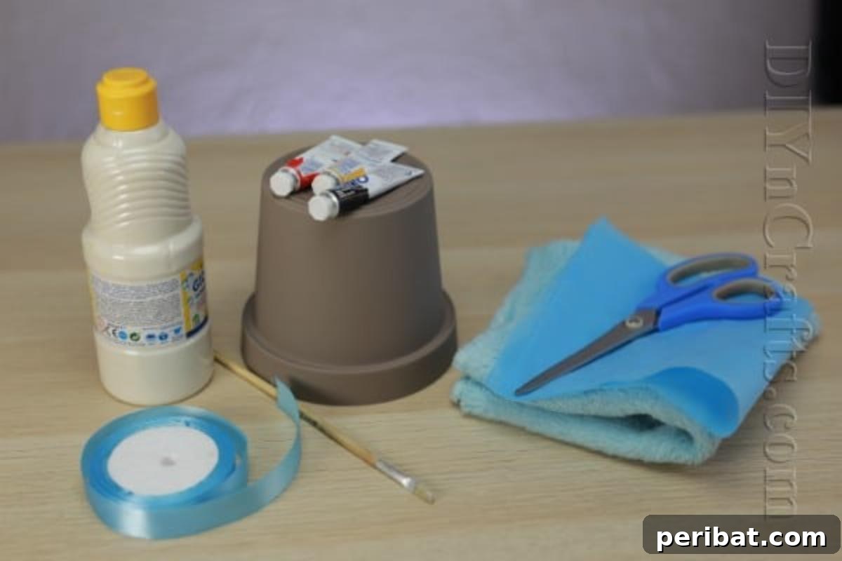 DIY Adorable Flower Pot Snowman 3 Project materials for a cute snowman from a flower pot including paints, ribbon, and fabric.