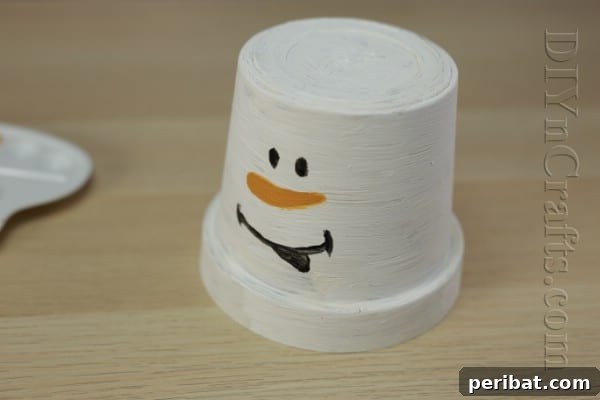 DIY Adorable Flower Pot Snowman 8 Paint the snowman's smiling mouth