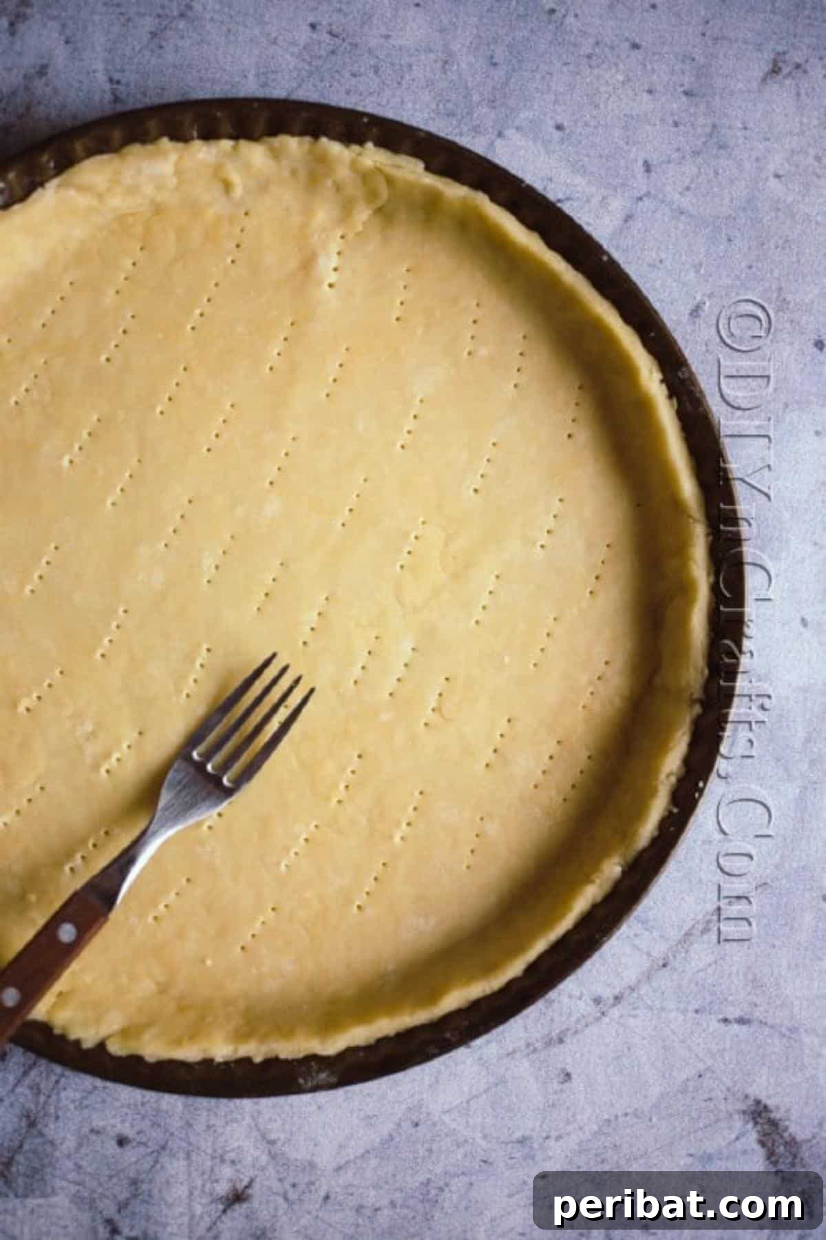 Delicate Autumn Harvest Tart 6 Poking holes in the tart crust before blind baking