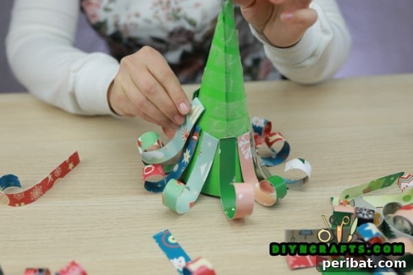 Miniature Cardstock Strip Christmas Tree Craft 17 Starting the second layer of cardstock strips on the cone