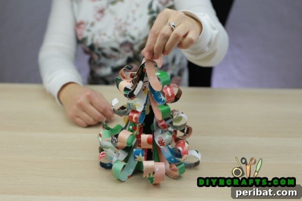 Miniature Cardstock Strip Christmas Tree Craft 18 Continuing to layer cardstock strips all the way to the top of the tree