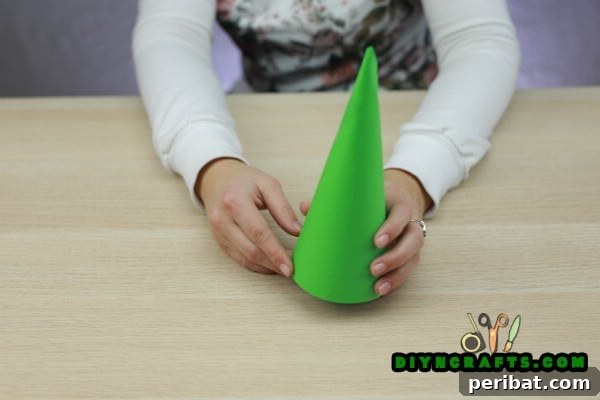 Miniature Cardstock Strip Christmas Tree Craft 9 Folding the cut paper into a cone shape and taping it