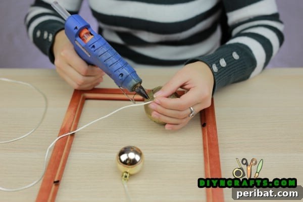 Securing ornament to string with a knot and hot glue