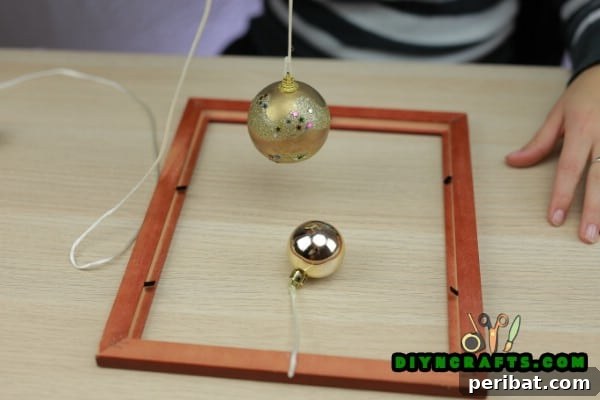 Attaching ornaments to the back of a picture frame with hot glue