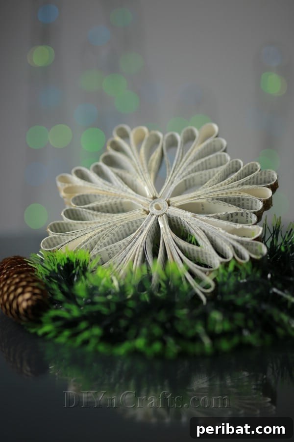 Creative Snowflakes From Vintage Book Pages 22 Close-up of a multi-sided book page snowflake with intricate paper curls.