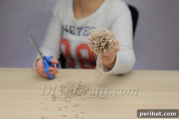 Trimming a pom pom into a perfect sphere
