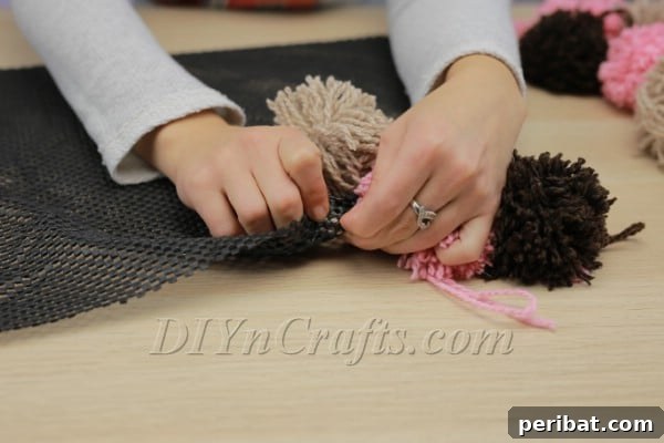 Beautiful DIY Pom Pom Rugs Made Easy 13 Pushing pom pom yarn ends through rug pad mesh