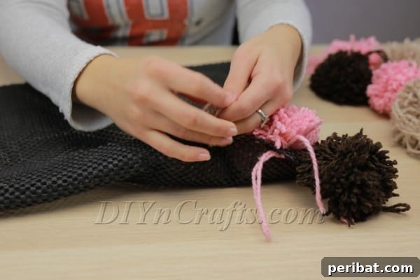 Beautiful DIY Pom Pom Rugs Made Easy 15 Securely tied pom pom on rug pad