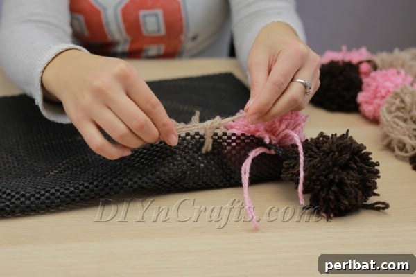Close-up of attached pom pom on rug pad