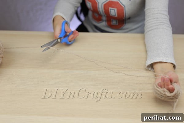 Cutting a long piece of yarn for tying