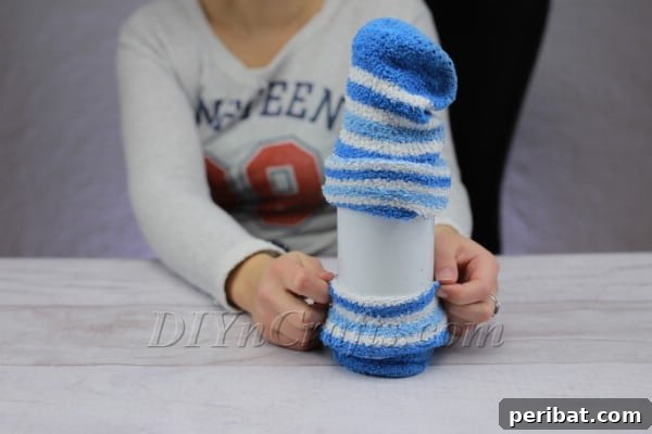 Dressing the bottle snowman with a second sock acting as a warm coat or scarf