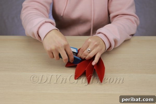 Transform Construction Paper into Festive Poinsettias 11 Step 10a: Pinching and fanning the papers
