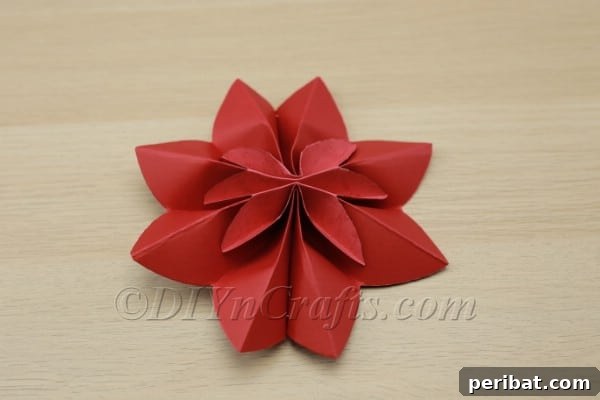 Transform Construction Paper into Festive Poinsettias 12 Step 10b: Stapling the ends to form the flower