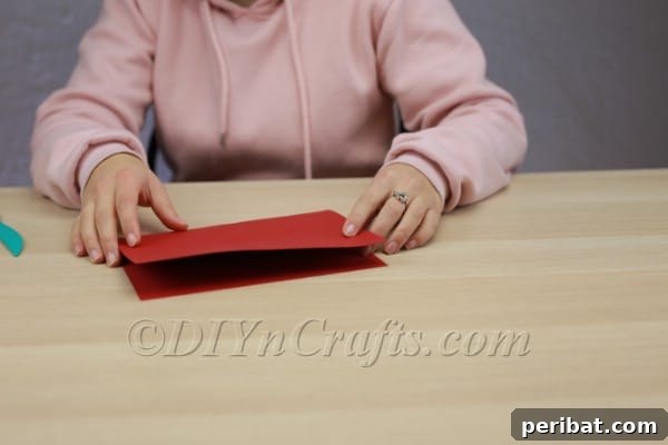 Transform Construction Paper into Festive Poinsettias 4 Step 1: Folding the large paper in half