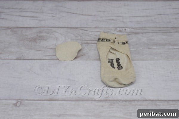 Craft Your Own Scandinavian Rice Sock Gnome 12 Cutting a circular piece of fabric from a sock to form the gnome's nose