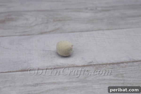Craft Your Own Scandinavian Rice Sock Gnome 16 Nose stuffed with cotton and thread pulled tight to securely form its spherical shape