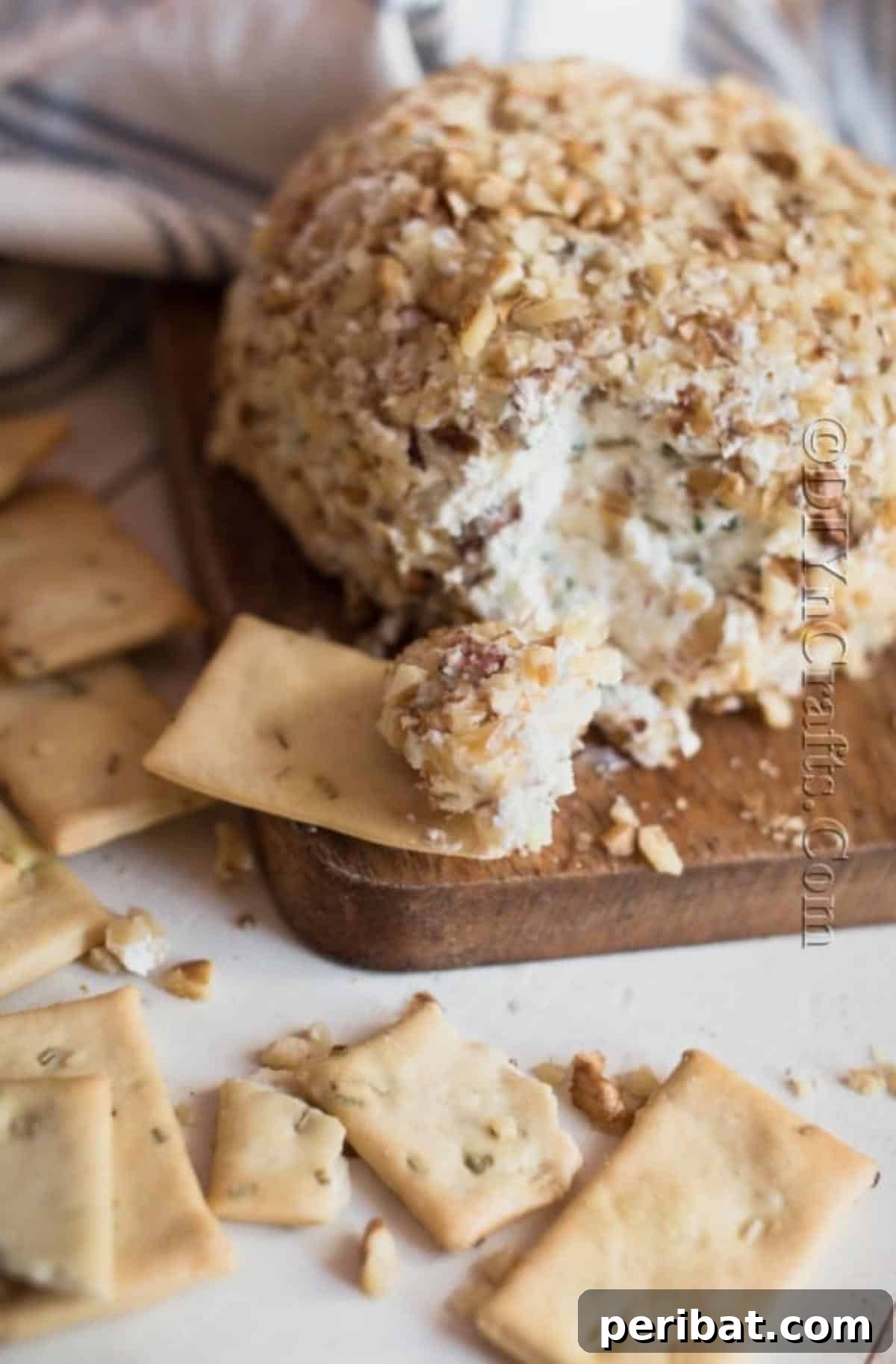 The Ultimate Party Cheese Ball 7 The finished chilled bacon ranch cheese ball, beautifully coated in walnuts and ready to be served on a platter.