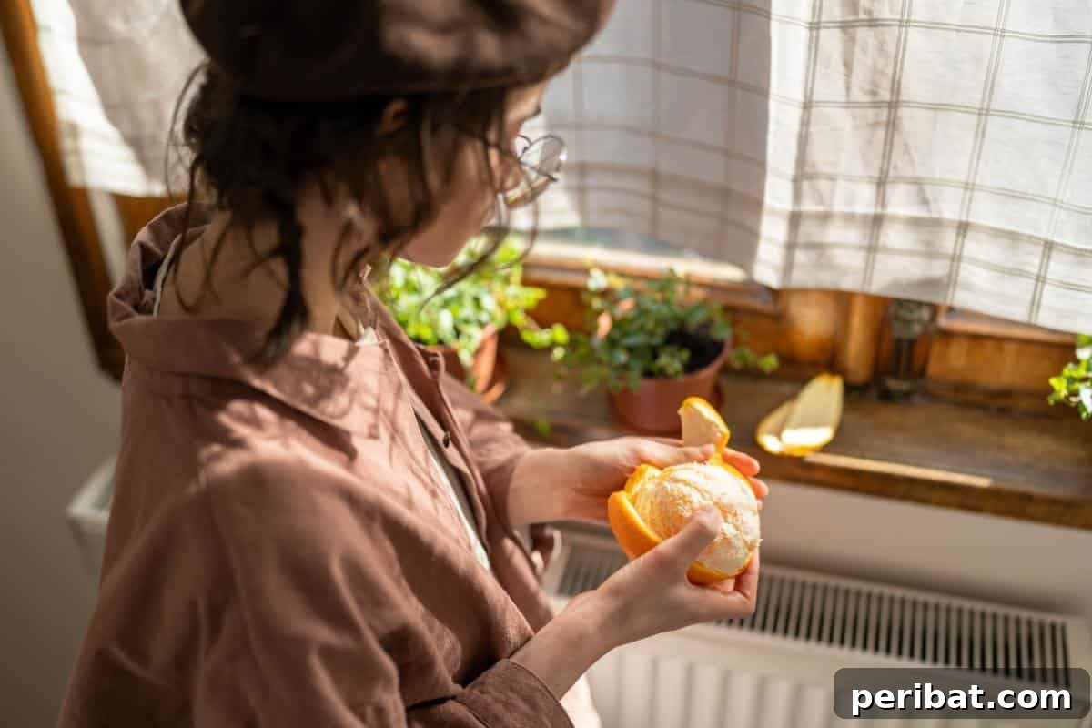 Beyond the Bin: 20 Brilliant Ways to Repurpose Fruit and Vegetable Peels 10 Peeling an orange.