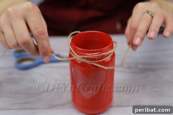 Spark Romance: Create Your Own Valentine Heart Lantern 11 Tying twine around the jar neck for decoration