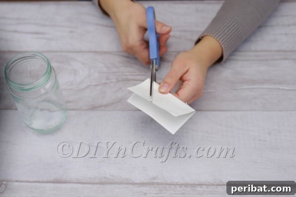 Spark Romance: Create Your Own Valentine Heart Lantern 4 Cutting a heart shape from adhesive paper for the lantern