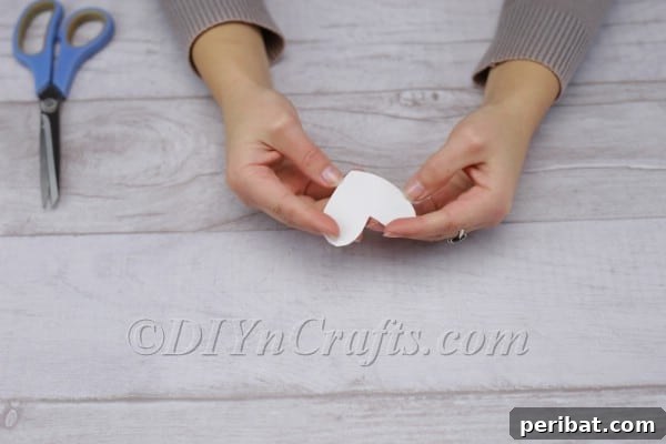 Spark Romance: Create Your Own Valentine Heart Lantern 5 Peeling the backing off adhesive heart
