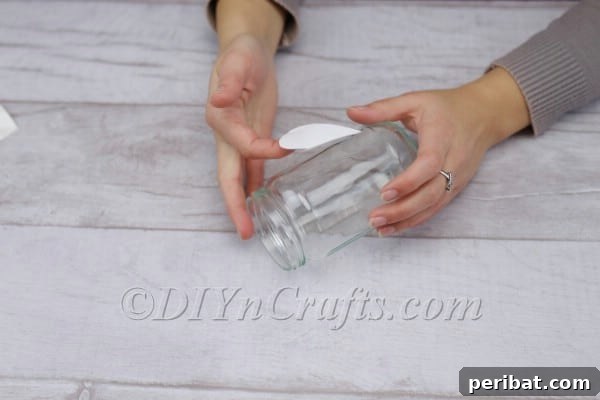 Spark Romance: Create Your Own Valentine Heart Lantern 6 Applying tape to a paper heart for the lantern