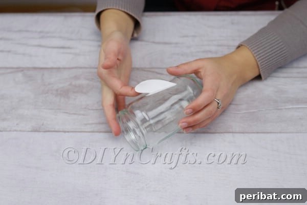 Spark Romance: Create Your Own Valentine Heart Lantern 7 Carefully pressing the paper heart onto the jar