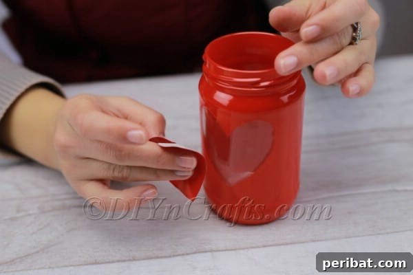 Spark Romance: Create Your Own Valentine Heart Lantern 10 Peeling off the adhesive heart to reveal clear glass