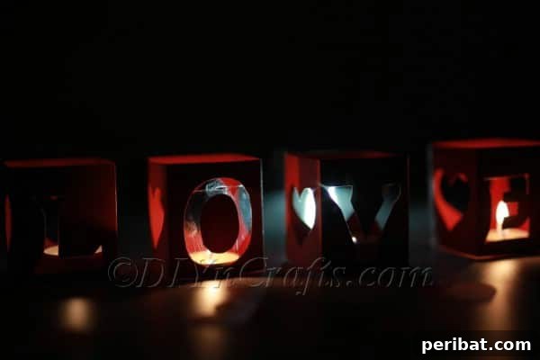 Placing tea lights inside the paper lanterns