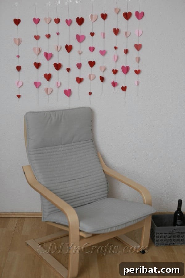 Vertical paper heart garlands decorating a wall