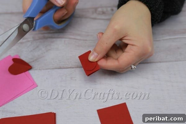 Construction paper squares in various sizes for heart garland