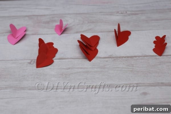 Cutting out matching paper heart shapes