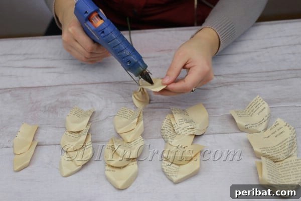 Attaching the first small petal to the artificial stem with hot glue