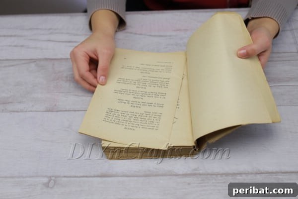 Stack of torn book pages ready for crafting