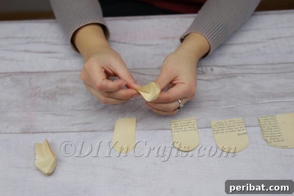 Literary Blooms: Crafting a Heartfelt Book Bouquet 9 Gently pinching and curling the bottom edge of a paper petal
