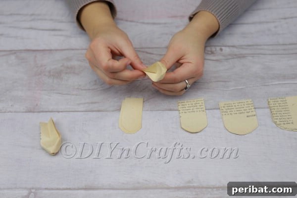 Literary Blooms: Crafting a Heartfelt Book Bouquet 10 Folding over the top edges of the curved arc for a natural curl