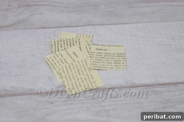 Stack of cut book page squares.