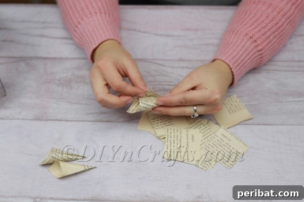 Rolling a book page square into a cone.