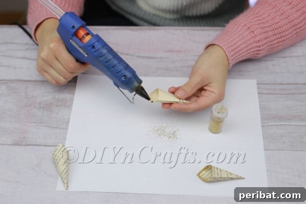 Sprinkling glitter onto the glue.