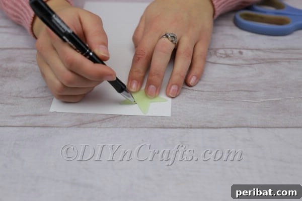 Tracing a star stencil onto cardboard.