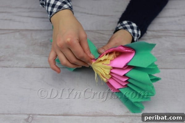Tape securing the center of the pinched tissue paper
